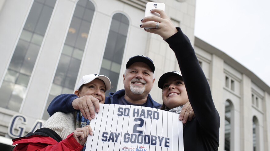 Fans take a photo outside Yankee Stadium before Derek Jeter's final home game on Thursday.