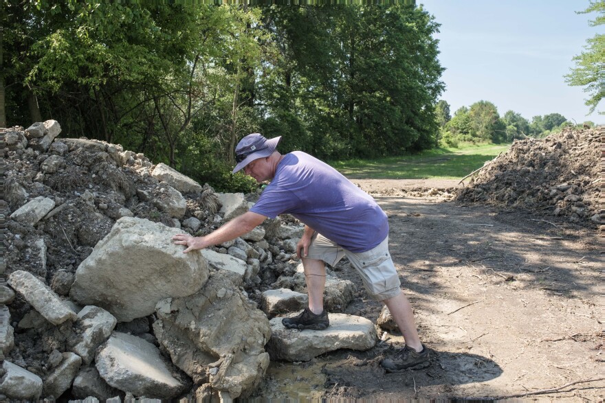 Jim Duxbury shows the conctete slabs that were broken up in order to build a stretch of a Rails to Trails path that runs behind Lavender Trails. Orrville, Ohio. July 11, 2025.