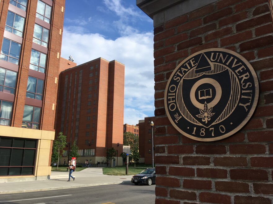 A student walks past a building at Ohio State University.