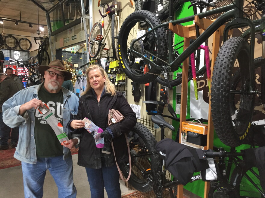 Renard and Mary Ellen Turner from Cleveland found bicycle socks -- with humorously ribald messages on them -- during their first visit to the Northside Marketplace, on Small Business Saturday.