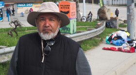 Leonardo Torres stands in Pajaro, at the foot of the Pajaro river bridge. He says if he leaves, he won't be allowed back home.