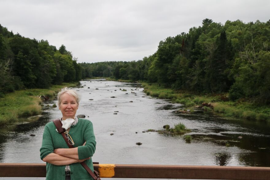 Sharri Venno, environmental planner for the Houlton Band of Maliseet Indians, stands in front of a section of Meduxnekeag River that's been restored to a more natural state that better suits salmon and other native species.