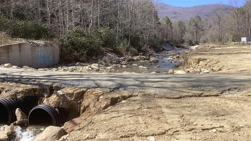 An eroded streambank causes pieces of rode to crumble in Buncombe County.