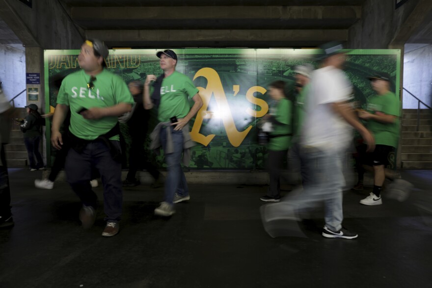 Fans walk inside of the Oakland Coliseum, before a baseball game between the Athletics and the Tampa Bay Rays in Oakland, Calif., Tuesday, June 13, 2023. (AP Photo/Jed Jacobsohn)