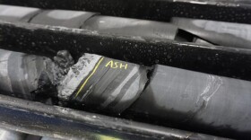A layer of ancient volcanic ash is exposed in a core sample at the Donlin Mine exploration camp on Aug. 11, 2022.