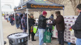 Federal workers wait for food distribution to begin Saturday at a pop-up food bank in Rockville, Md. The Capital Area Food Bank is distributing free food to government employees during the shutdown.