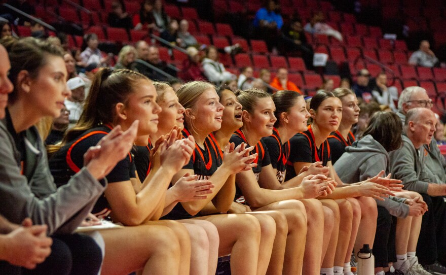 Girls high school basketball players inside an arena