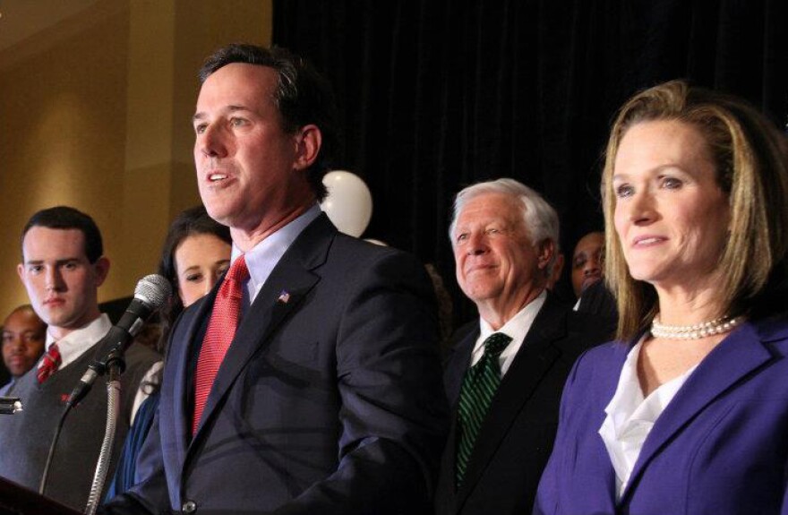 Rick Santorum celebrates his wins in Missouri, Minnesota and Colorado on Feb 7. Those wins gave him momentum in Michigan. Rival Mitt Romney says Santorum is going too far to try to get votes in Michigan.