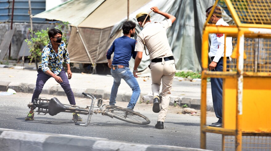 Delhi police react to commuters not complying with the lockdown imposed by the government to curb the spread of coronavirus.