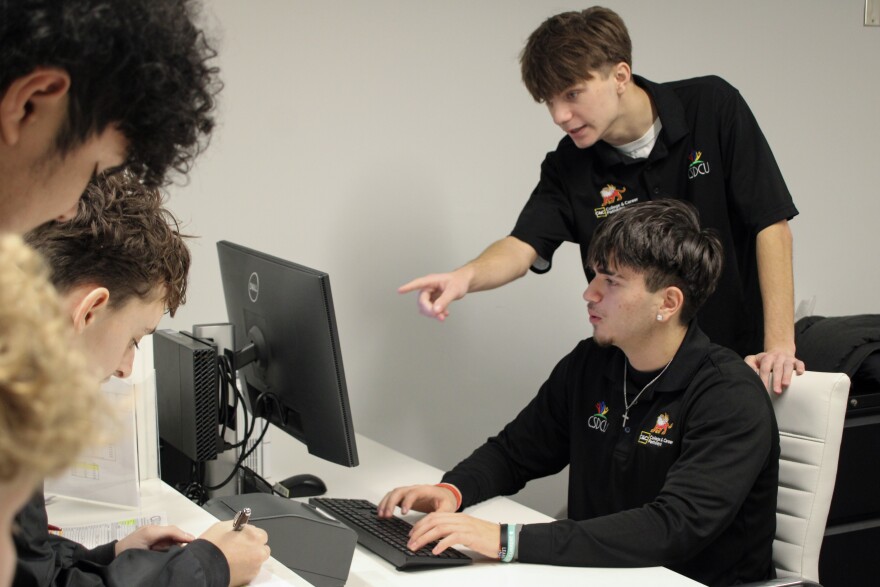 Seniors David Milosevic and Adam Magnuson work at the CSD Credit Union branch located inside their high school.