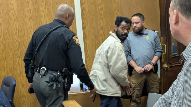 Bruce Foster III, center, called out, "I'm innocent," as he left a Licking County courtroom after a short hearing. A doctor's competency evaluation found he should be hospitalized before facing trial. A judge approved a prosecutor's request for a second opinion. Foster is accused of killing two people and injuring several others in a shooting at the KDC/One warehouse in New Albany in Feb. 2025.