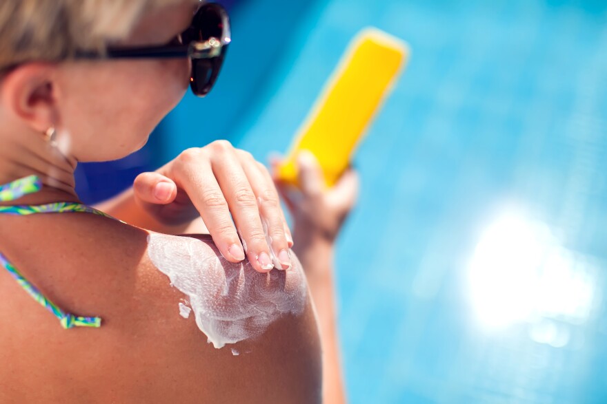 Woman applying sunscreen