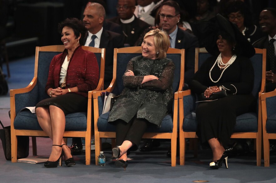 Former Secretary of State Hillary Clinton listens while her husband speaks. Before holding their many political offices, Bill Clinton said, the couple considered themselves "Aretha groupies."