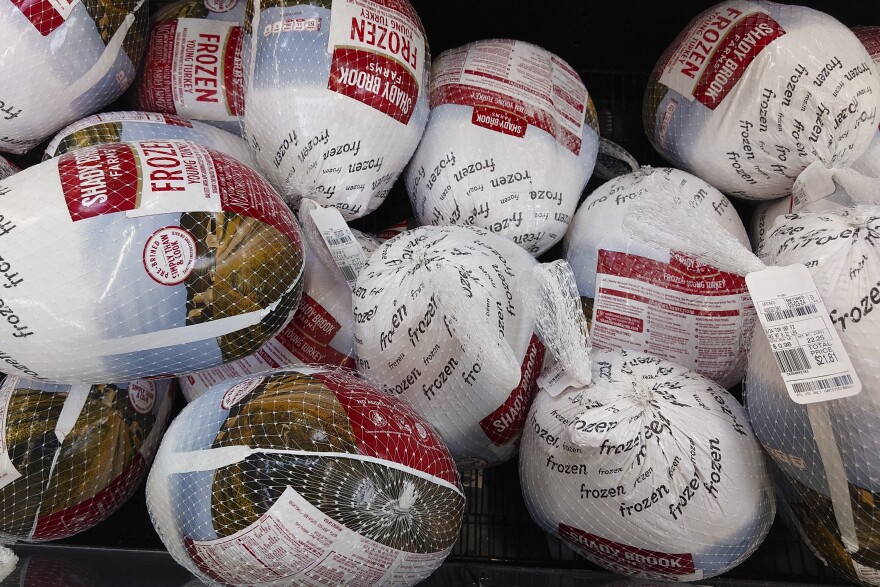 Frozen turkeys sit in a refrigerated case inside a grocery store in Philadelphia, Monday, Nov. 21, 2022.