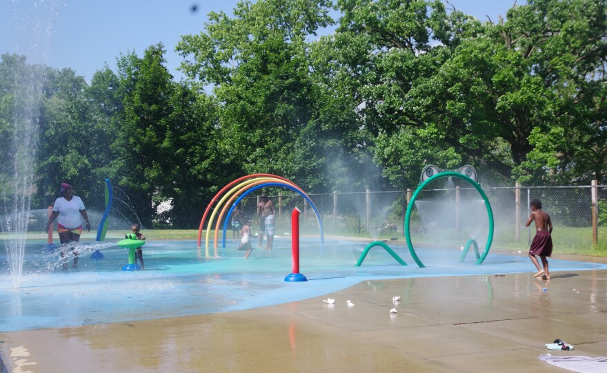 Kids and parents playing at a splash pad in Kalamazoo.