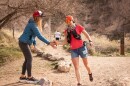 Race director Tara Warren high-fives Jill Wilkins, who ran six laps up and down Malan’s Peak in 12 hours during the annual Running Up For Air Malan’s Peak race, Feb. 28, 2026.
