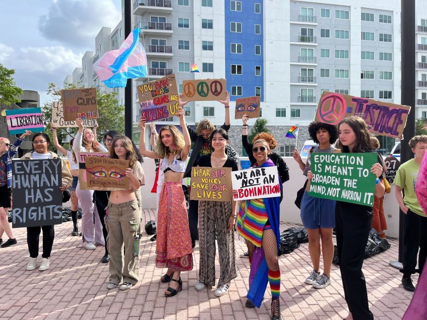 Students protest anti-LGBTQ policies outside the school board.