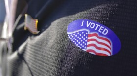 Brian Kennedy, a candidate campaign volunteer, wears his "I voted" sticker beside his American flag pin. (Keith Srakocic/AP)