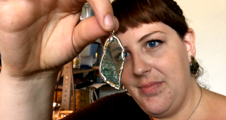 Deanna Dionne examines a newly created pendant [David C. Barnett / ideastream]