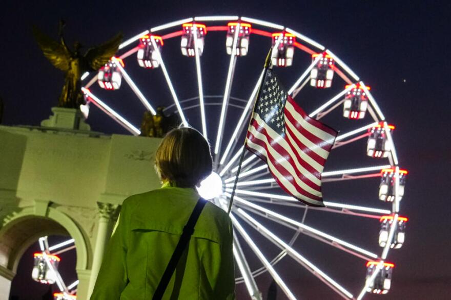 A person carries an American flag at the Great American State Fair, Tuesday, June 30, 2026, on the National Mall in Washington, D.C. (Julia Demaree Nikhinson/AP)