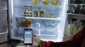 An LG representative shows off a smart refrigerator at the 2014 International Consumer Electronics Show in Las Vegas on Jan. 10.