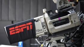 FILE - A television camera is viewed during an ESPN broadcast in the first half of a WNBA basketball game between the Connecticut Sun and the Minnesota Lynx, July 26, 2020, in Bradenton, Fla. (AP Photo/Phelan M. Ebenhack, File)