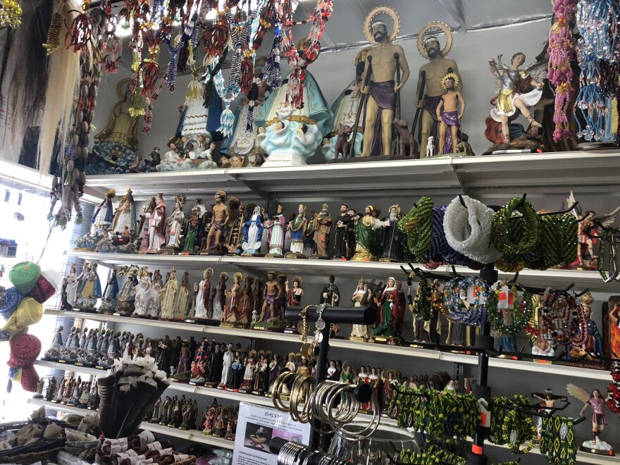 The interior of Botánica Nena, featuring an array of figures and statues of saints who are part of Afro-Caribbean traditions.