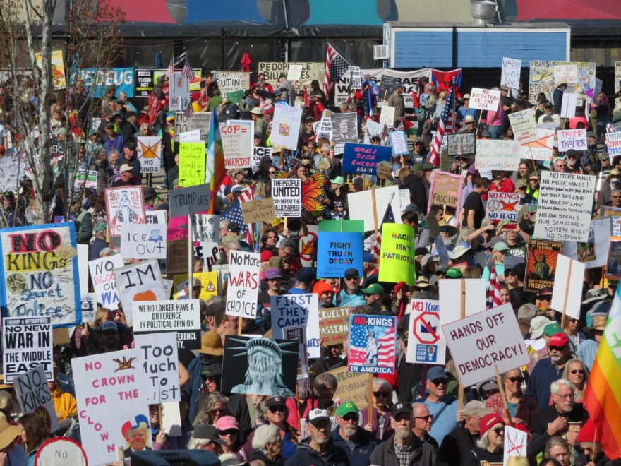 large crowd of people with protest signs