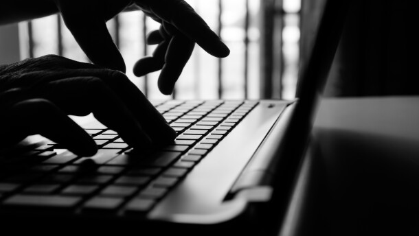 hacker or cyber crime hand reaching, stealing information on laptop, attack signifying internet theft while using online banking, anonymous business in technology internet and networking concept