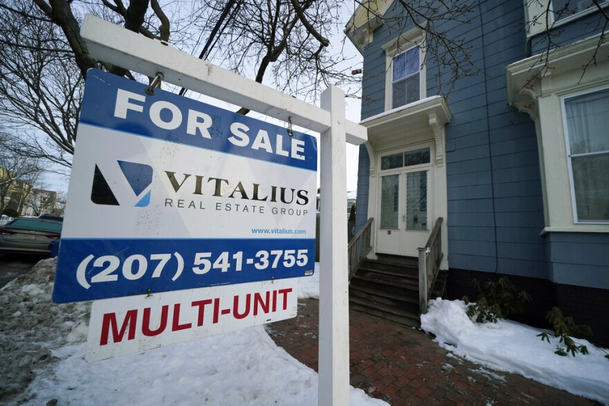 A sign announces a home for sale on Munjoy Hill, Wednesday, Jan. 25, 2023, in Portland, Maine. 