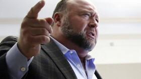 FILE - Alex Jones talks to media during a midday break in his trial at the Travis County Courthouse in Austin, Texas, on July 26, 2022. A six-member jury with several alternates in Connecticut will begin hearing evidence, Tuesday, Sept. 13, 2022, on how much Jones should pay the families, since he already has been found liable for damages to them. The trial is expected to last about four weeks. (Briana Sanchez/Austin American-Statesman via AP, Pool)