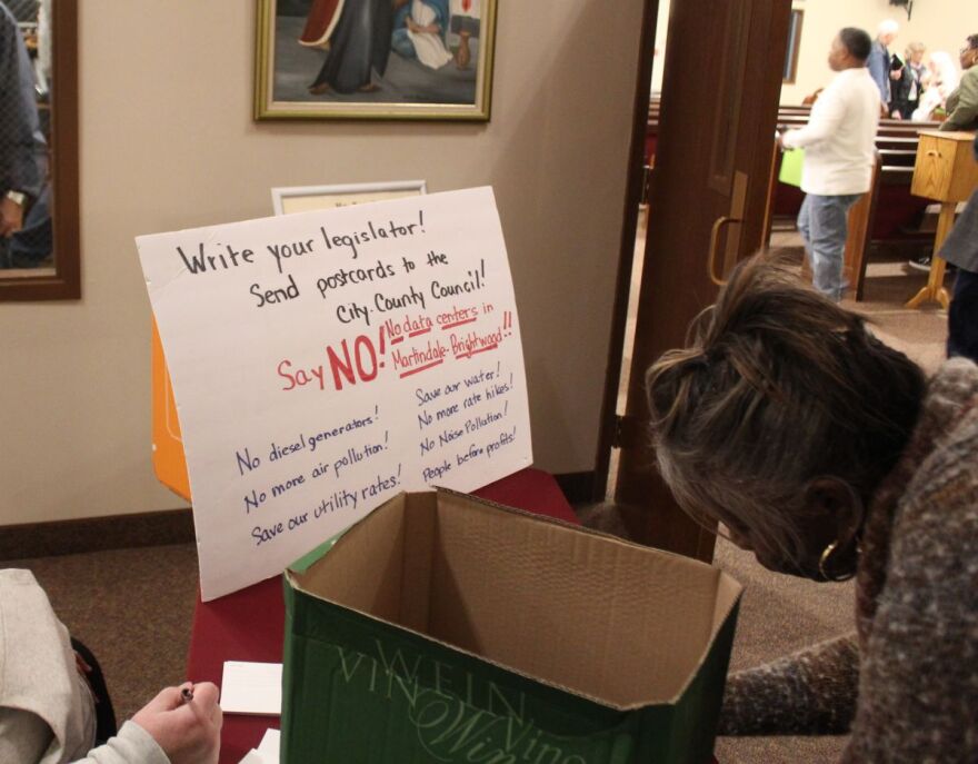 Residents write down their concerns about a proposed data center in Martindale-Brightwood in Indianapolis after a community meeting on Thursday, Jan. 8, 2026. 