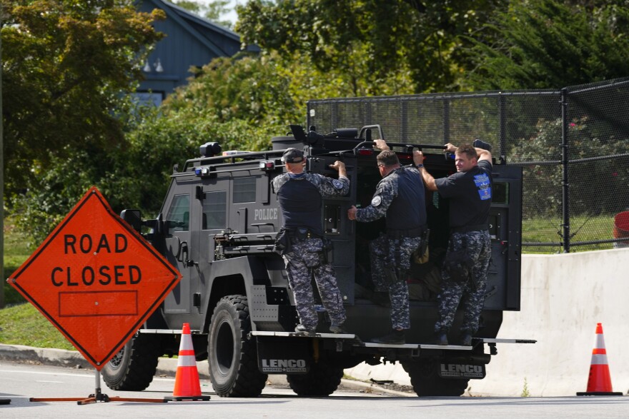 Law enforcement officers ride by a roadblock as the search for escaped convict Danelo Cavalcante continues in Pottstown, Pa., Tuesday, Sept. 12, 2023. 