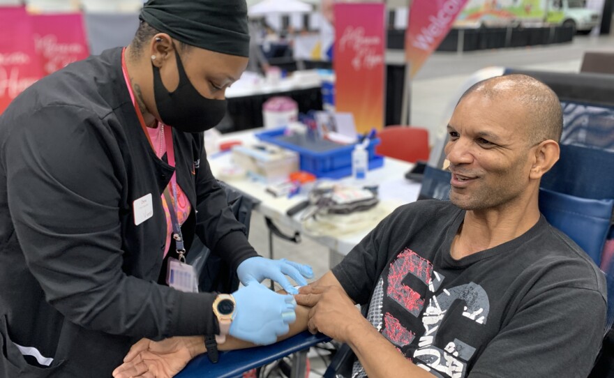 Adam Richardson donating blood at Indiana Black Expo