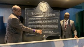 Negro Leagues Baseball Museum President Bob Kendrick, right, and Vice President Raymond Doswell talk about the defaced Jackie Robinson Birthplace historical marker the museum unveiled Friday morning.