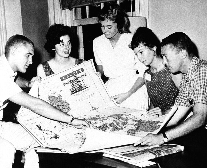 Five Peace Corps trainees look at a map of the Philippine Islands in University Park, Pa. on July 31, 1961. The trainees will go there upon completion of training as teaching assistants in rural elementary schools. 