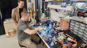 Electro Magnetic Applications scientists Brian Wood (standing) and Justin Christensen (seated) hard at work in the Pittsfield, Massachusetts, lab.