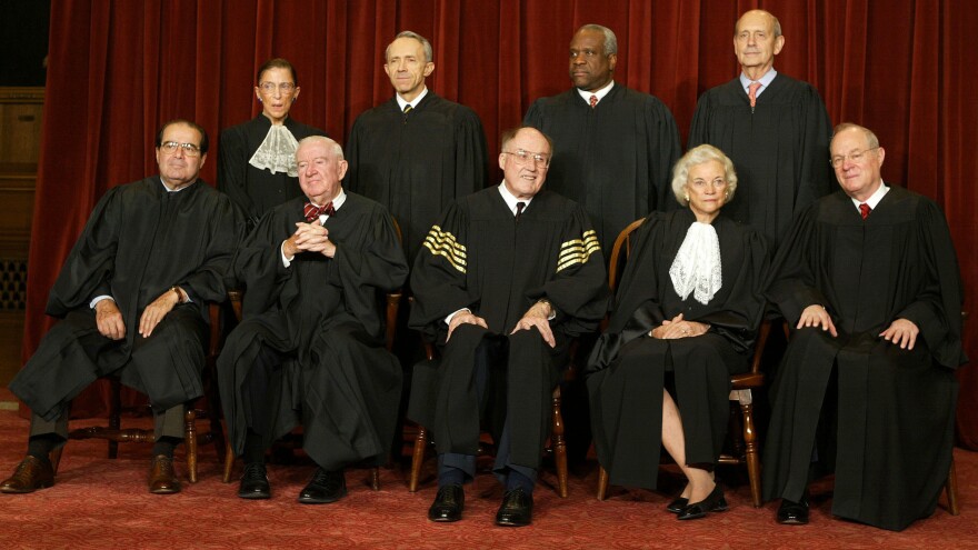 O'Connor and Rehnquist are pictured with the other Supreme Court justices for a photo in 2003.