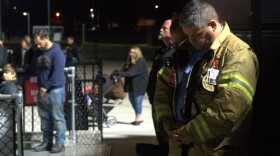 A firefighter bows his head in prayer as the memorial comes to a close.