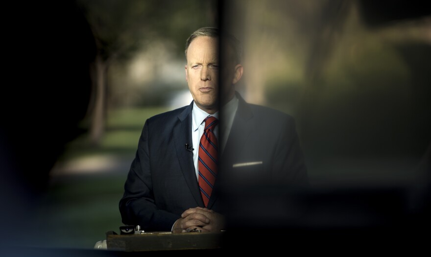 White House press secretary Sean Spicer waits for an interview on Tuesday to speak about a comparison he made between Syria's President Bashar Assad and Hitler during an earlier press briefing at the White House.