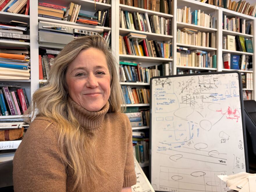 Katharine Elkins sits in her office at Kenyon College's campus. She's leading an effort to use AI to preserve historical archives.