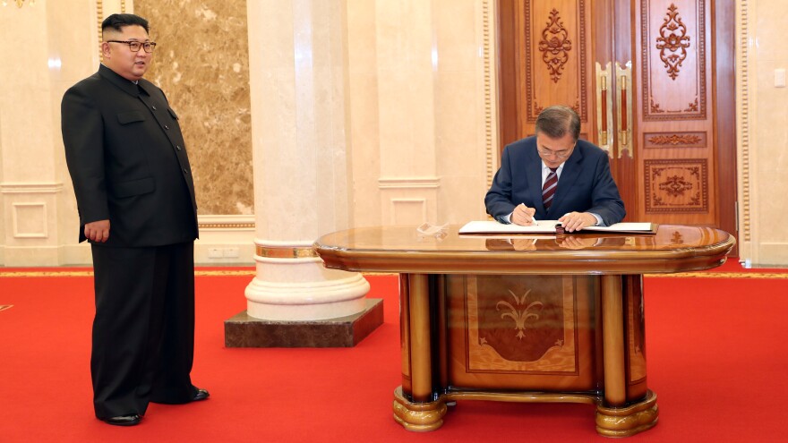 Signing in: South Korean President Moon Jae-in signs a guestbook as North Korean leader Kim Jong Un looks on at the headquarters of the Central Committee of the Workers' Party of Korea in Pyongyang, North Korea.