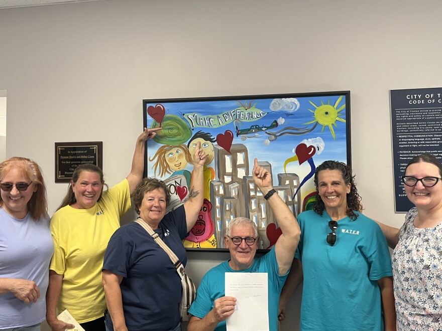 Members of the Woodsdale and Trenton Environmental Resistance group pose for a picture in the city building after submitting a petition seeking to change the city charter to prohibit the construction of data centers over 25 megawatts.
