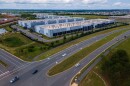 Cars drive past data centers that house computer servers and hardware required to support modern internet use, such as artificial intelligence, in Ashburn, Virginia, July 16, 2023.