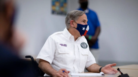Texas Gov. Greg Abbott meets with local leaders in El Paso last month to discuss the coronavirus situation. At an event Thursday, he proposed enhancing certain penalties for crimes related to protests. 