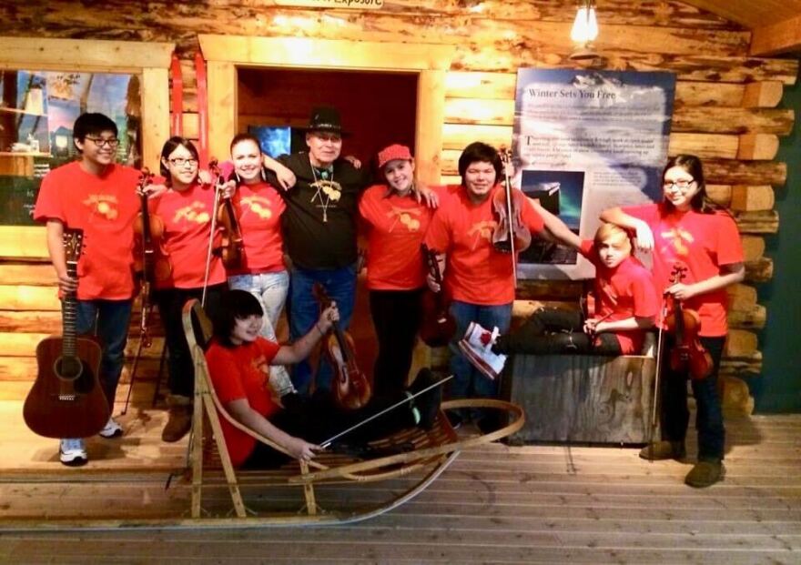 Bill Stevens pictured with his music students at the Morris Thompson Cultural and Visitors Center.