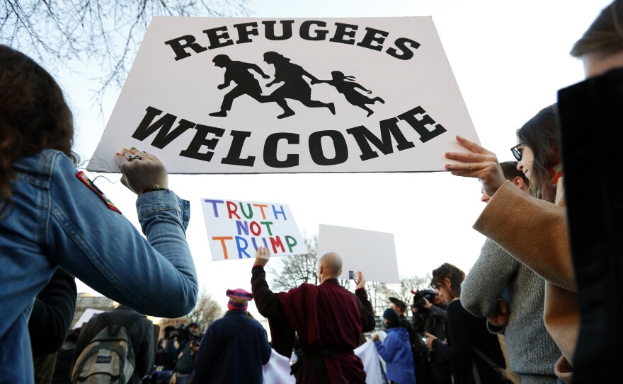 Protesters hold signs near the White House during a protest about President Trump's immigration policies on Wednesday. A proposed presidential action would freeze immigration from seven mostly Muslim countries for security reasons. But the list does not include any of the countries whose nationals have killed Americans in the U.S. since Sept. 11, 2001.