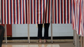 A voter filling out their ballot behind the patriotic curtain at Rye Elementary School on Sept. 8, 2026.