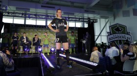 Reign FC's Beverly Yanez  models her team's new  jersey Jan. 17 during an event to unveil a jersey sponsorship with Zulily. The Reign is moving to Cheney Stadium in Tacoma, and S2 is rebranding as Tacoma Defiance. 