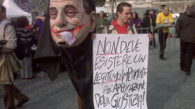In Rome, thousands took to the streets to protest a culture of corruption that seemingly has become pervasive. This poster derides a bill being pushed by Prime Minister Silvio Berlusconi that would shield him from prosecution while in office.